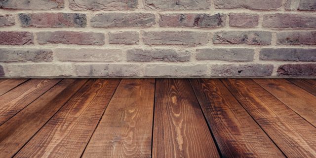 Reclaimed Wood Flooring with Brick Wall